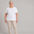Woman about 70 wearing the white built-in bra T-shirt, front view